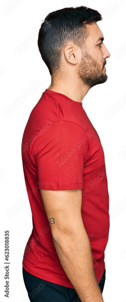 Sticker young hispanic man wearing casual clothes looking to side, relax profile pose with natural face with