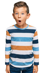 Adorable caucasian kid wearing casual clothes scared and amazed with open mouth for surprise,...