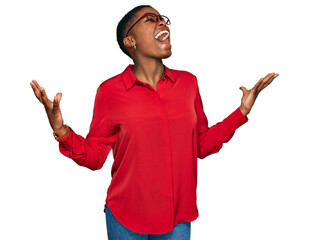 Young african american woman wearing casual clothes and glasses crazy and mad shouting and yelling...