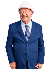 Senior handsome grey-haired man wearing suit and architect hardhat winking looking at the camera with sexy expression, cheerful and happy face.