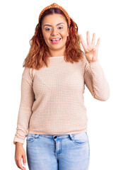 Young latin woman wearing casual clothes and diadem showing and pointing up with fingers number four while smiling confident and happy.
