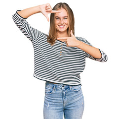 Fototapeta premium Beautiful blonde woman wearing casual clothes smiling making frame with hands and fingers with happy face. creativity and photography concept.