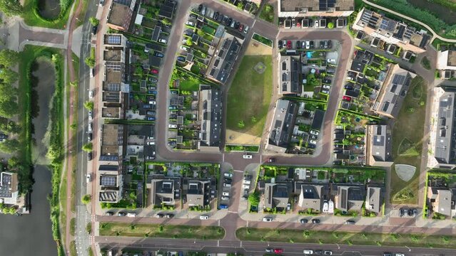 Aerial riser above housing project in lush environment, Weesp, Netherlands