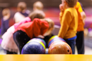 Children are playing bowling. Extracurricular activities for children. Bowling balls and bowling...