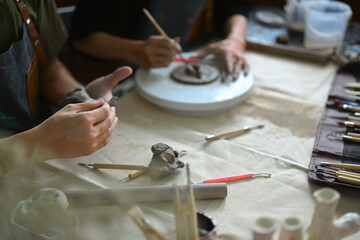 Obraz premium Two young men friends are enjoying creative process, creating handmade ceramics in workshop