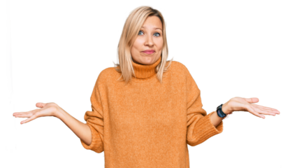 Middle age caucasian woman wearing casual winter sweater clueless and confused with open arms, no idea concept.