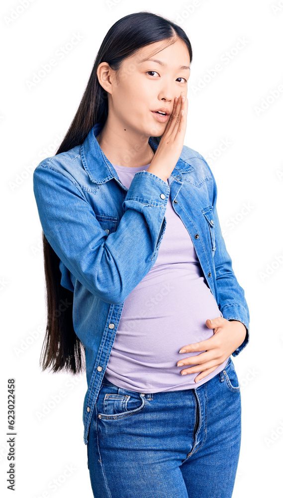 Sticker Young beautiful chinese woman pregnant expecting baby hand on mouth telling secret rumor, whispering malicious talk conversation