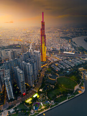 Aerial view of a Ho Chi Minh City, Vietnam with development buildings, transportation, energy power infrastructure. Financial and business centers. Sunset to night.