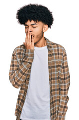 Young african american man with afro hair wearing casual clothes bored yawning tired covering mouth with hand. restless and sleepiness.