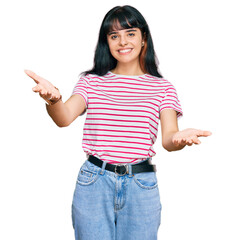 Young hispanic girl wearing casual clothes smiling cheerful offering hands giving assistance and acceptance.