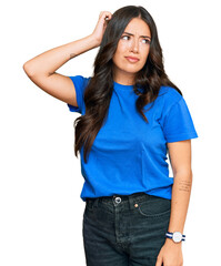 Beautiful brunette young woman wearing casual clothes confuse and wondering about question....