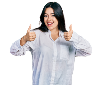 Beautiful hispanic woman wearing casual white shirt success sign doing positive gesture with hand, thumbs up smiling and happy. cheerful expression and winner gesture.
