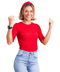 Obraz na płótnie Canvas Beautiful caucasian woman wearing casual clothes and red diadem screaming proud, celebrating victory and success very excited with raised arms