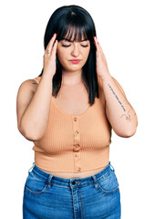 Young hispanic plus size woman wearing casual clothes with hand on head for pain in head because stress. suffering migraine.