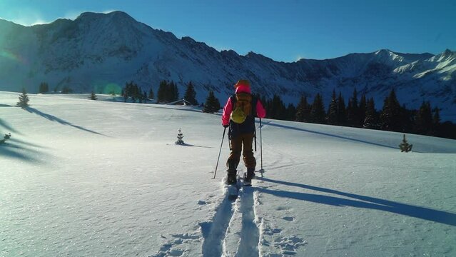 Cinematic stunning Colorado early morning Rocky Mountain backcountry skier split boarder up hill hiking fresh snow top peaks light treeline level Copper Breckenridge Aspen Vail follow zoom in out pan