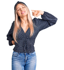 Young beautiful blonde woman wearing casual clothes stretching back, tired and relaxed, sleepy and...