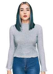 Young modern girl wearing casual sweater relaxed with serious expression on face. simple and...