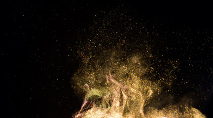 Golden sparks, gold powder, dust, magic Christmas and New Year glittering stars swirl on black...