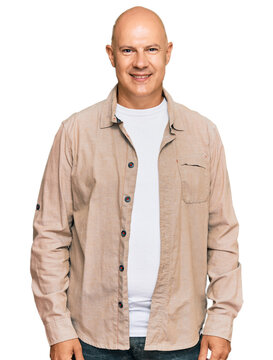 Middle age bald man wearing casual clothes with a happy and cool smile on face. lucky person.