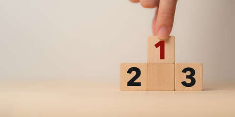 Number 1 on the podium with number 2, 3 of wooden building blocks. Ranking, business strategy,...