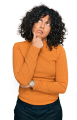 Young hispanic woman wearing casual clothes thinking worried about a question, concerned and nervous with hand on chin