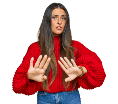 Beautiful hispanic woman wearing casual clothes moving away hands palms showing refusal and denial with afraid and disgusting expression. stop and forbidden.