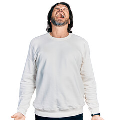 Middle age caucasian man wearing casual clothes angry and mad screaming frustrated and furious, shouting with anger. rage and aggressive concept.