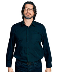 Middle age caucasian man wearing casual clothes and glasses relaxed with serious expression on face. simple and natural looking at the camera.