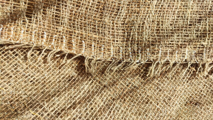 Natural fabric texture, frame and background of burlap. Rough crumpled burlap background. Selective and partial focus