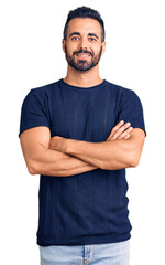 Young hispanic man wearing casual clothes happy face smiling with crossed arms looking at the camera. positive person.