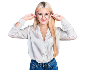Beautiful blonde woman wearing elegant shirt and glasses smiling pulling ears with fingers, funny...