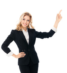 Happy smiling young businesswoman, pointing at something or showing copy space area for slogan or...