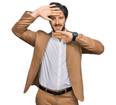 Young hispanic man wearing business clothes smiling cheerful playing peek a boo with hands showing face. surprised and exited