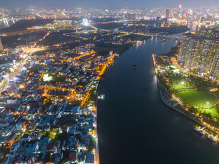 Aerial view of a Ho Chi Minh City, Vietnam with development buildings, transportation, energy power infrastructure. Financial and business centers. Sunset to night.