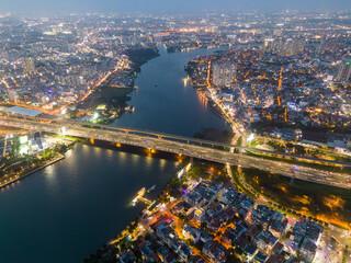 Obraz premium Aerial view of a Ho Chi Minh City, Vietnam with development buildings, transportation, energy power infrastructure. Financial and business centers. Sunset to night.