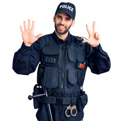 Young handsome man with beard wearing police uniform showing and pointing up with fingers number eight while smiling confident and happy.