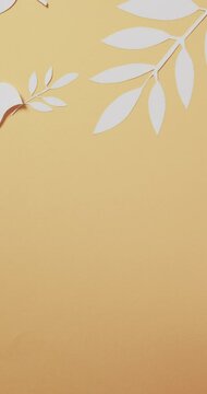 Vertical video of white dove with leaves and copy space on yellow background