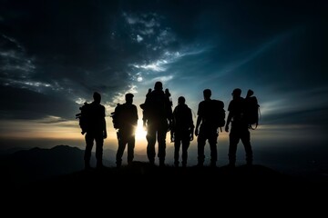 Fototapeta na wymiar Triumph at Sunset: Silhouetted Group of Hikers on Mountain Top