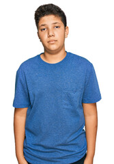 Teenager hispanic boy wearing casual clothes relaxed with serious expression on face. simple and natural looking at the camera.