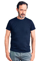 Fototapeta premium Middle age handsome man wearing casual t-shirt skeptic and nervous, frowning upset because of problem. negative person.
