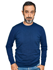 Fototapeta premium Middle age hispanic man wearing casual clothes puffing cheeks with funny face. mouth inflated with air, crazy expression.