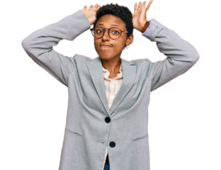 Young african american woman wearing business clothes doing bunny ears gesture with hands palms looking cynical and skeptical. easter rabbit concept.
