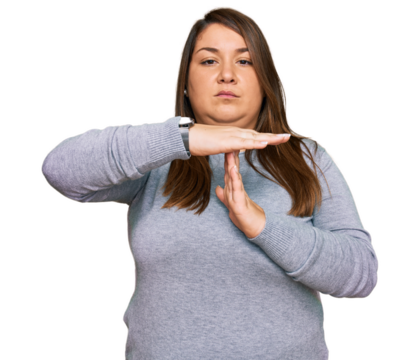 Beautiful brunette plus size woman wearing casual clothes doing time out gesture with hands, frustrated and serious face