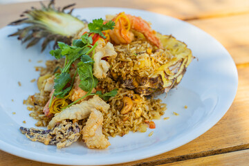 Seafood fried rice in pineapple, appetizing in a cafe next to the sea, Sue Flamingo, Ao Yon Beach, Phuket Thailand