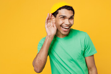 Young man of African American ethnicity he wearing casual clothes green t-shirt hat try to hear you...