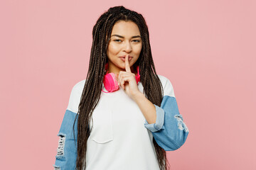 Young woman of African American ethnicity wearing white sweatshirt casual clothes headphones say...