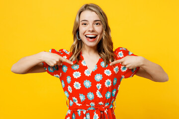 Young surprised shocked excited happy fun caucasian woman she wearing red dress casual clothes pointing index fingers on herself isolated on plain yellow background studio portrait. Lifestyle concept.