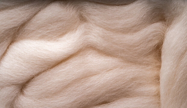White merino wool for felting as background. Merino wool for felting and needlework, hobby.