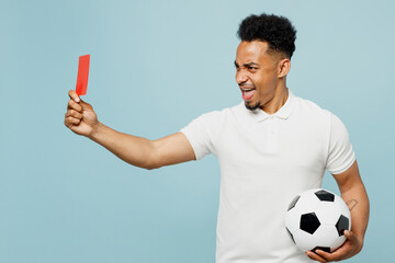 Side view young man fan in basic t-shirt cheer up support football sport team hold soccer ball, red...