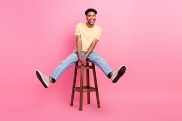 Full body length photo of young overjoyed man sitting stool carefree have fun positive good mood...